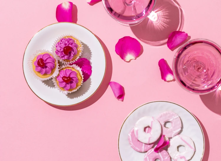 two bowls filled with pink doughnuts sitting on a table