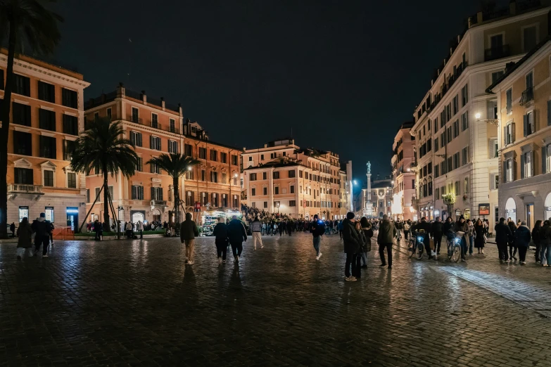 people are standing in the rain at night with lights on