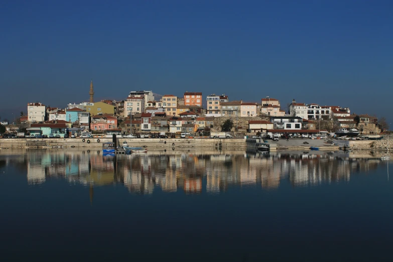 a city sitting on a hill above water