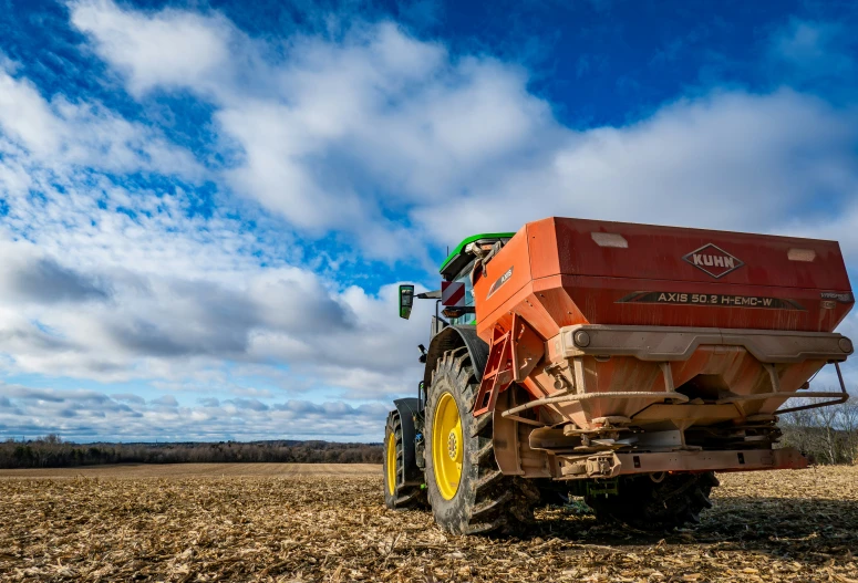 a tractor pulling a trailer across a field