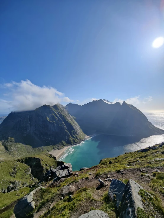 a mountain overlook with the sun in the distance