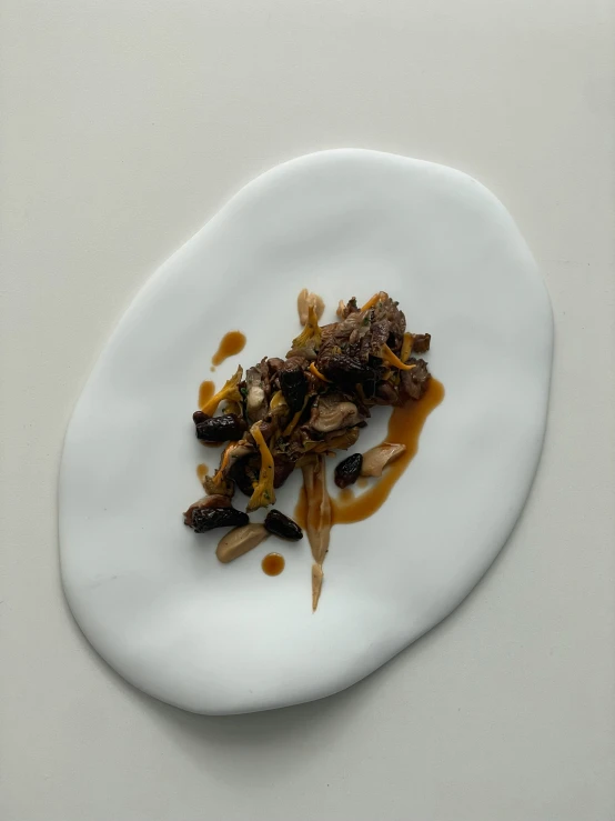 a small plate of food on a white surface