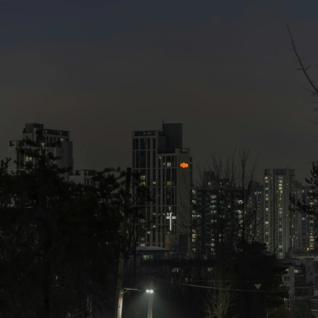 street signs are illuminated at night with city lights