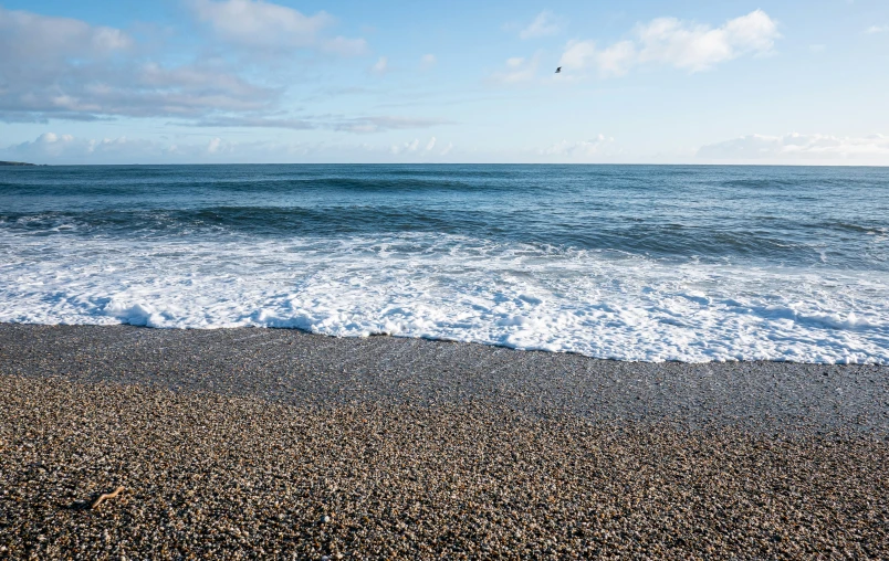 a surfer is out in the ocean looking towards the ocean