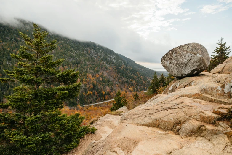 a rocky landscape with a large boulder on the left