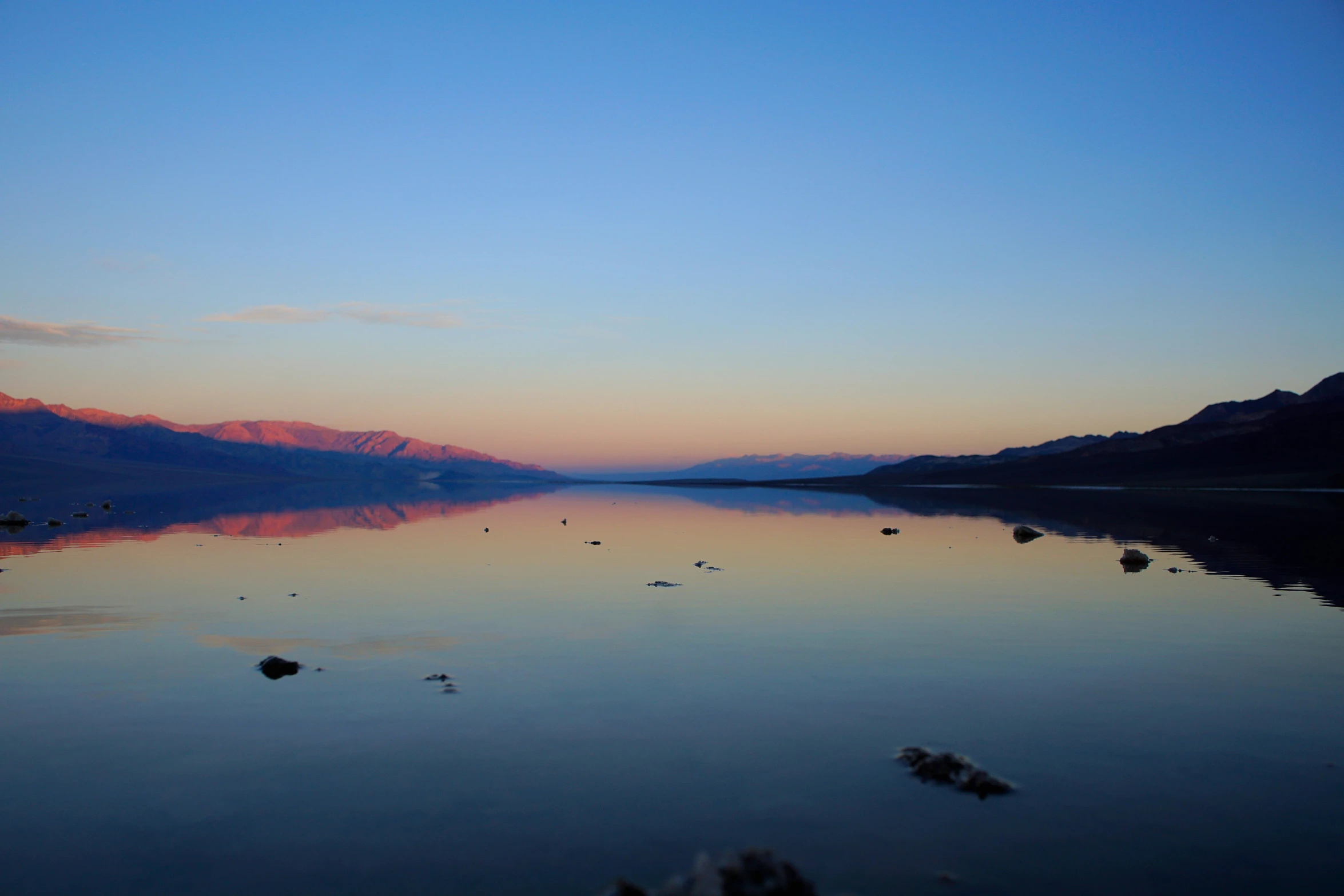 a po of the water with mountains in the background