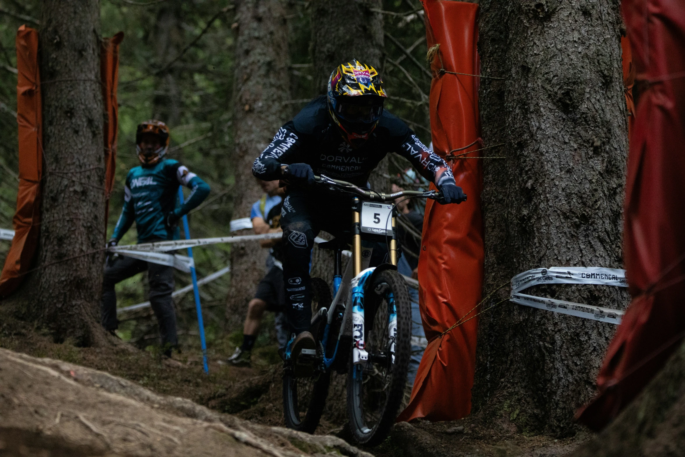 a man riding a bike down a forest