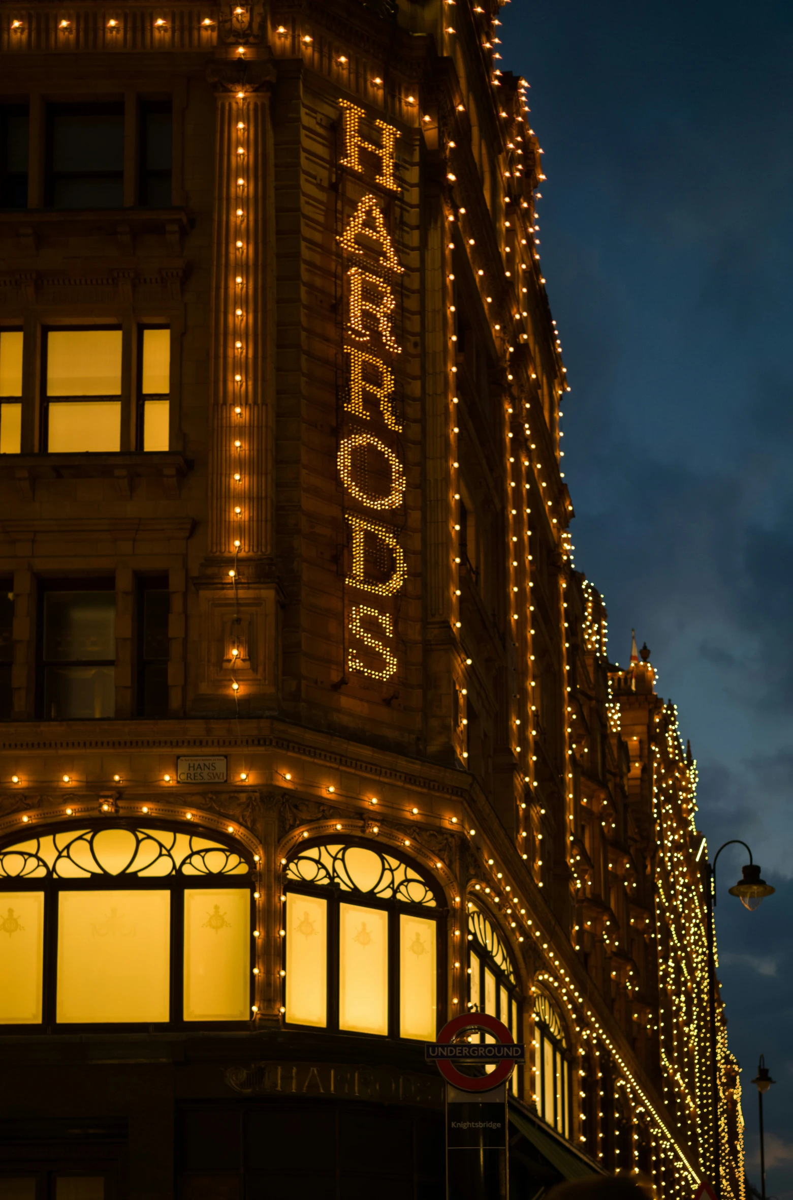 there are a lot of lights on the building that reads peace