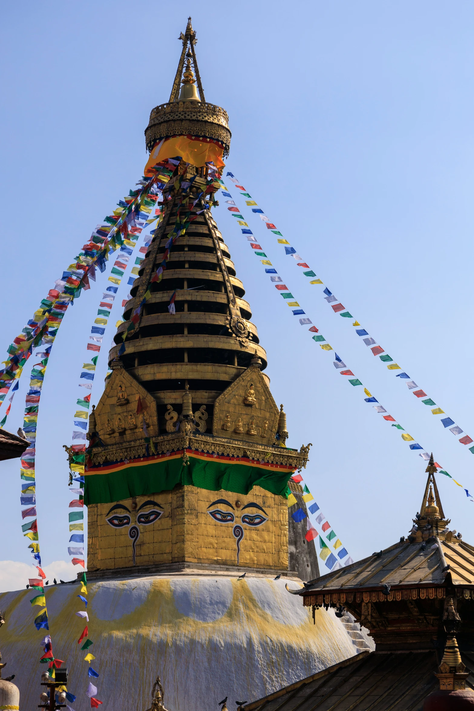 a temple with a tall steeple covered in flags