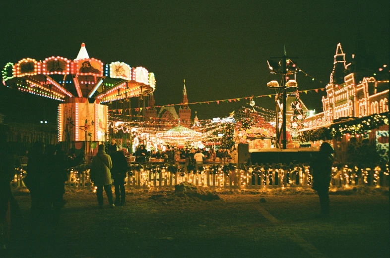 people are gathered around a merry go round carousel