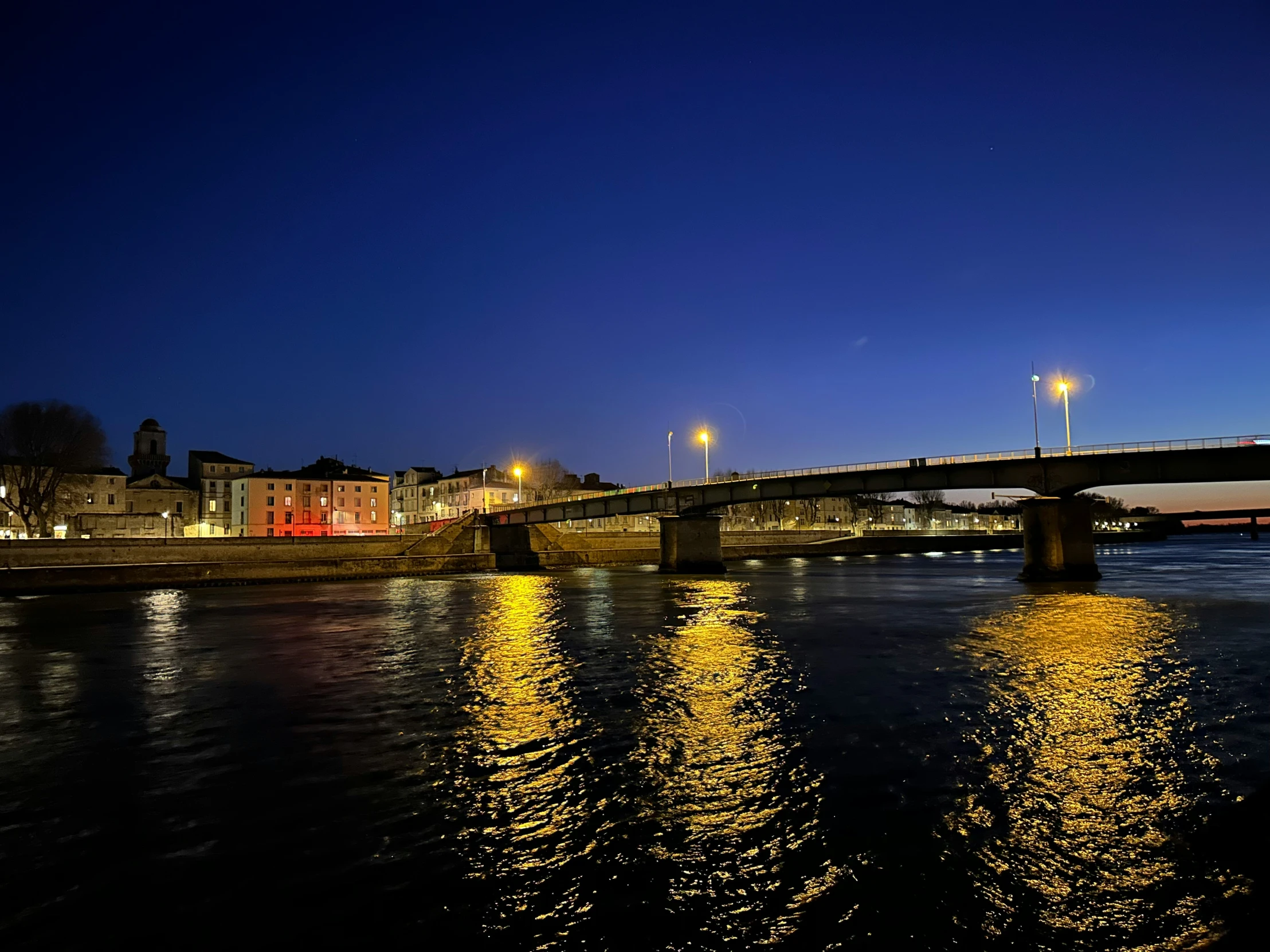 a bridge with a few lights reflected on it