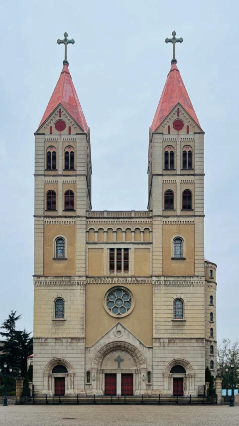 a large church with two towers and red roof