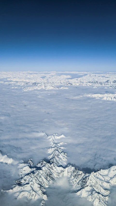 an aerial view of the clouds over a mountain