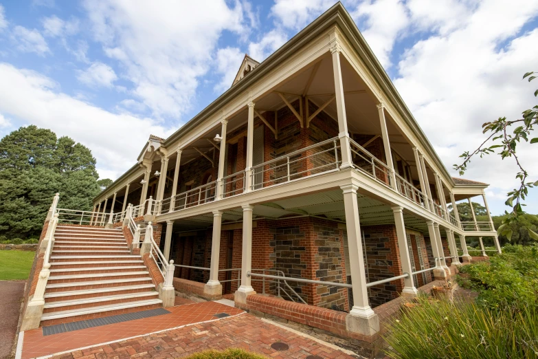 an old building with an overhang, stairs and windows