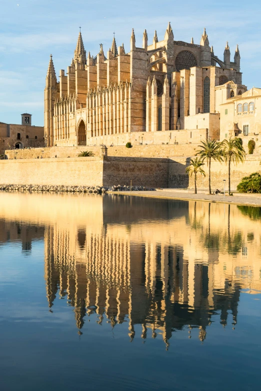 an old castle with a reflection in the water