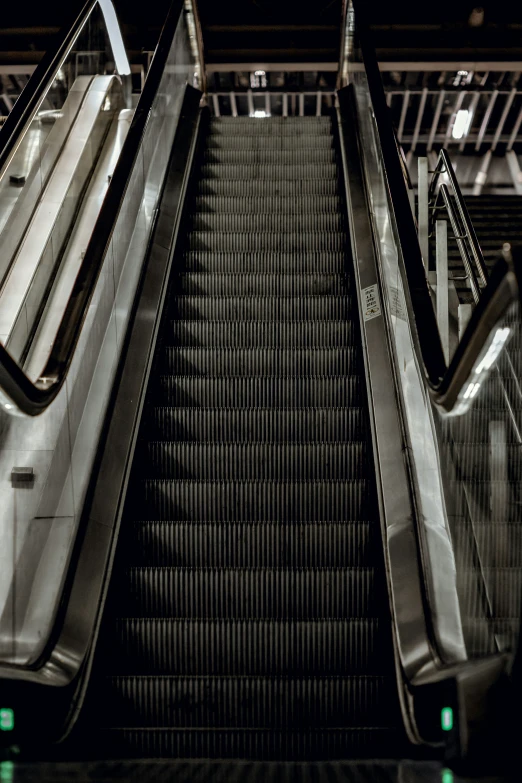 escalator at a city mall that has two people on each side