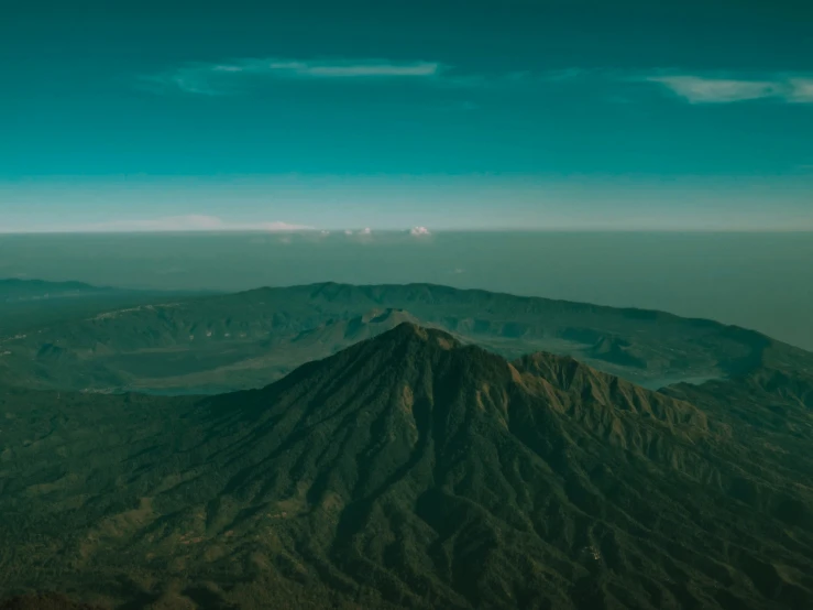 the view of some mountains in the distance with lots of dirt on it