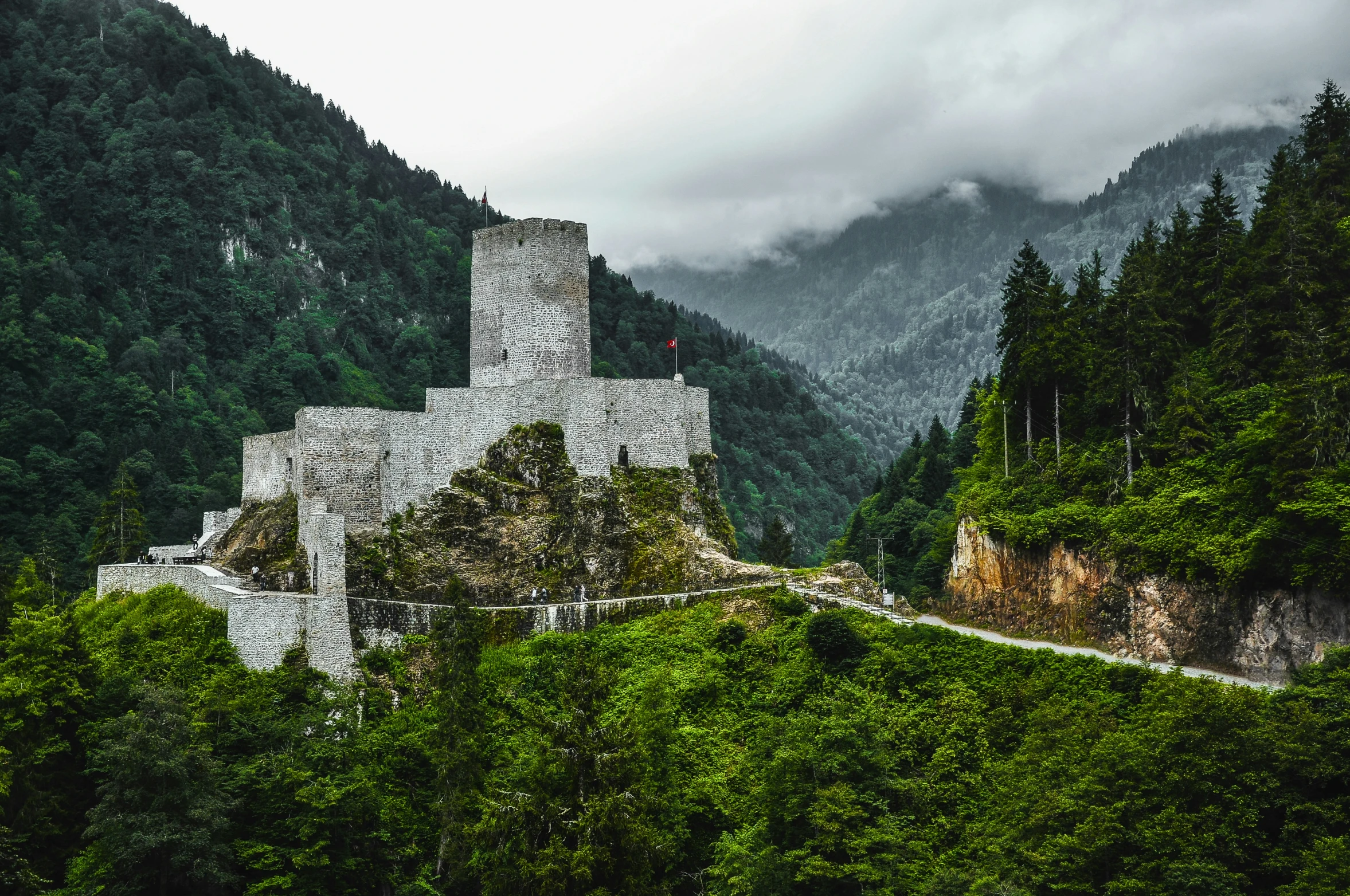 there is a castle sitting on top of the mountain