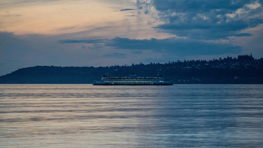 a passenger ferry coming into port in a twilight