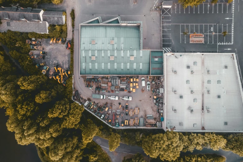 an overhead view of an industrial building with construction equipment