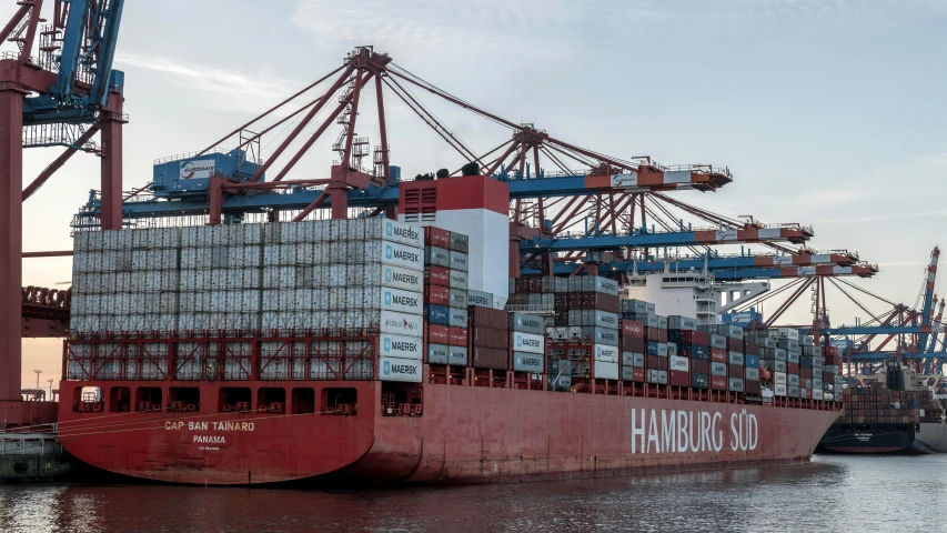 large cargo ship loaded with containers at dock