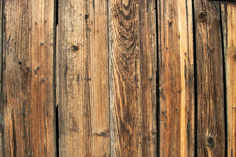 an old weathered wooden paneled door with wood lining