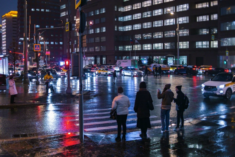 a city street is shown at night in the rain