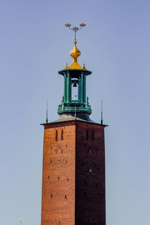 a very tall tower with a gold top on top