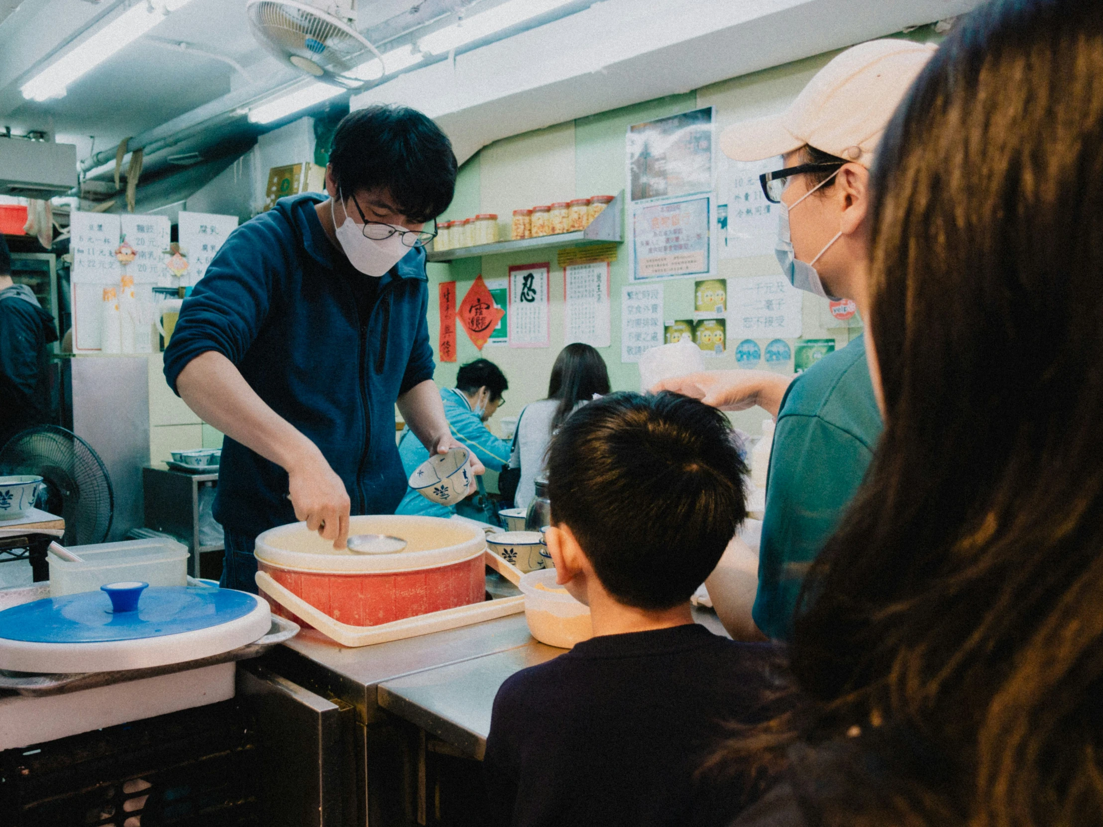 a group of people preparing food in a kitchen