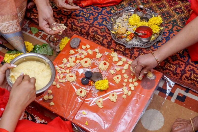 a number of people preparing food in bowls