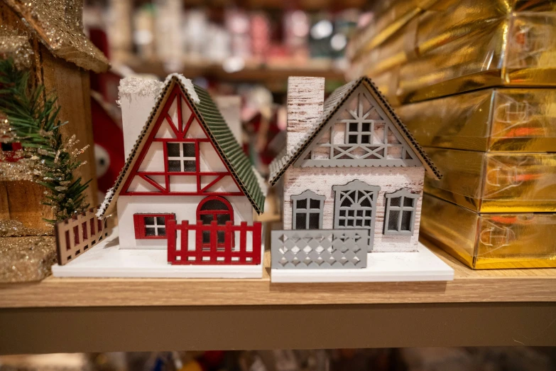 some small plastic houses on a wooden shelf