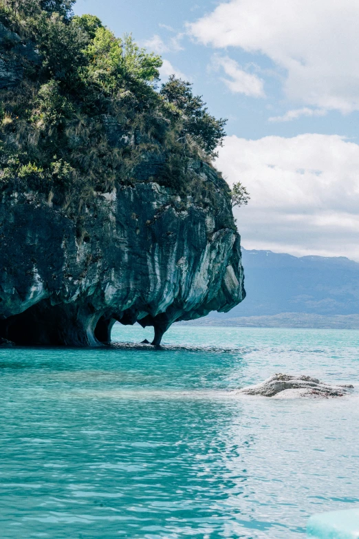 a body of water that has been partially surrounded by a cliff