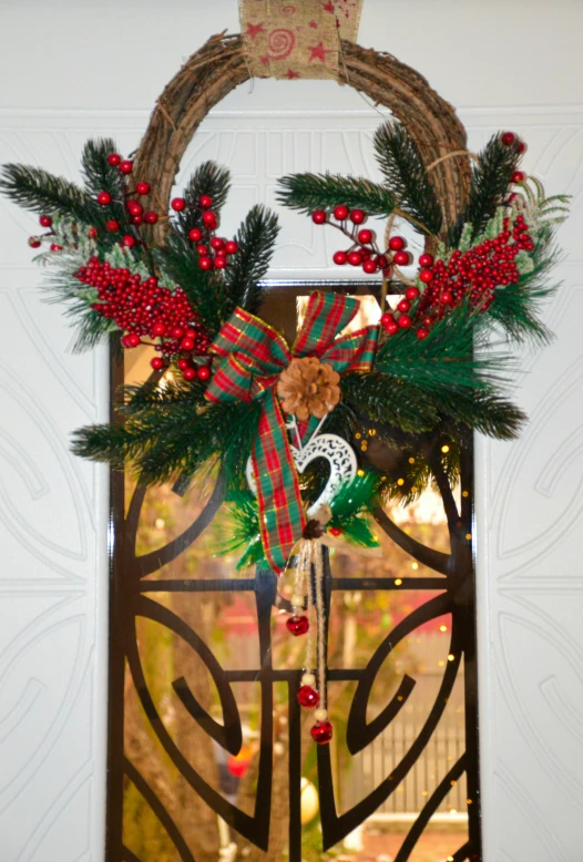 a christmas wreath and decorations hangs on the front door