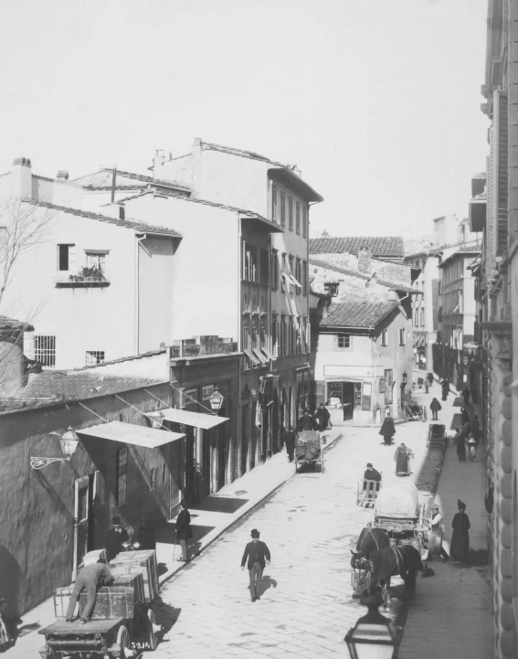 a view of people walking on an old city street