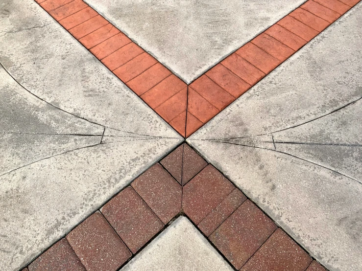 a cement sidewalk with red bricks on it