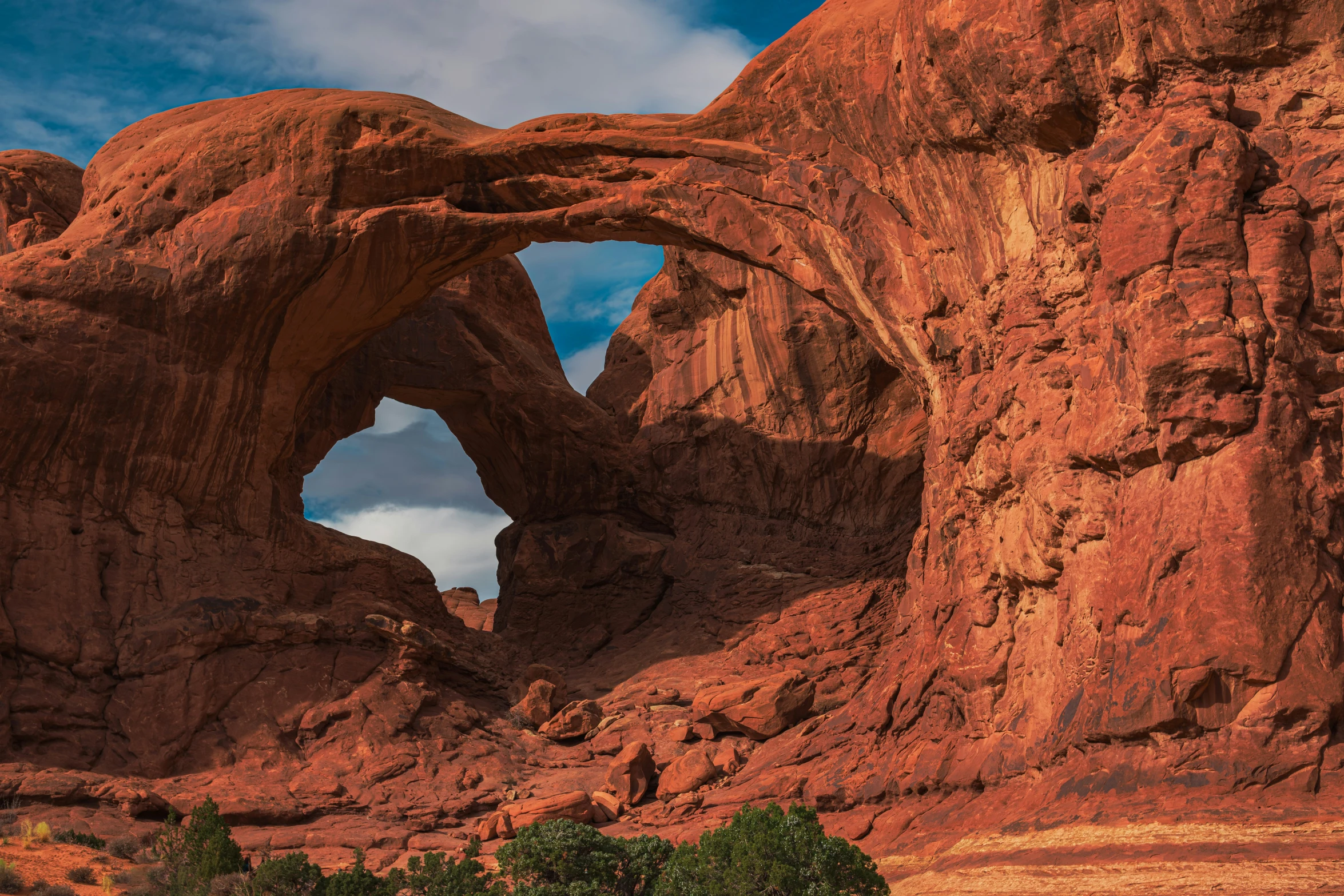 an arch shaped structure in a red rock wall