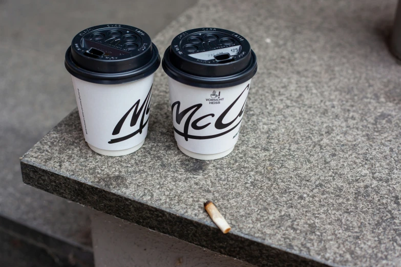 two coffee cups sitting side by side on a concrete countertop