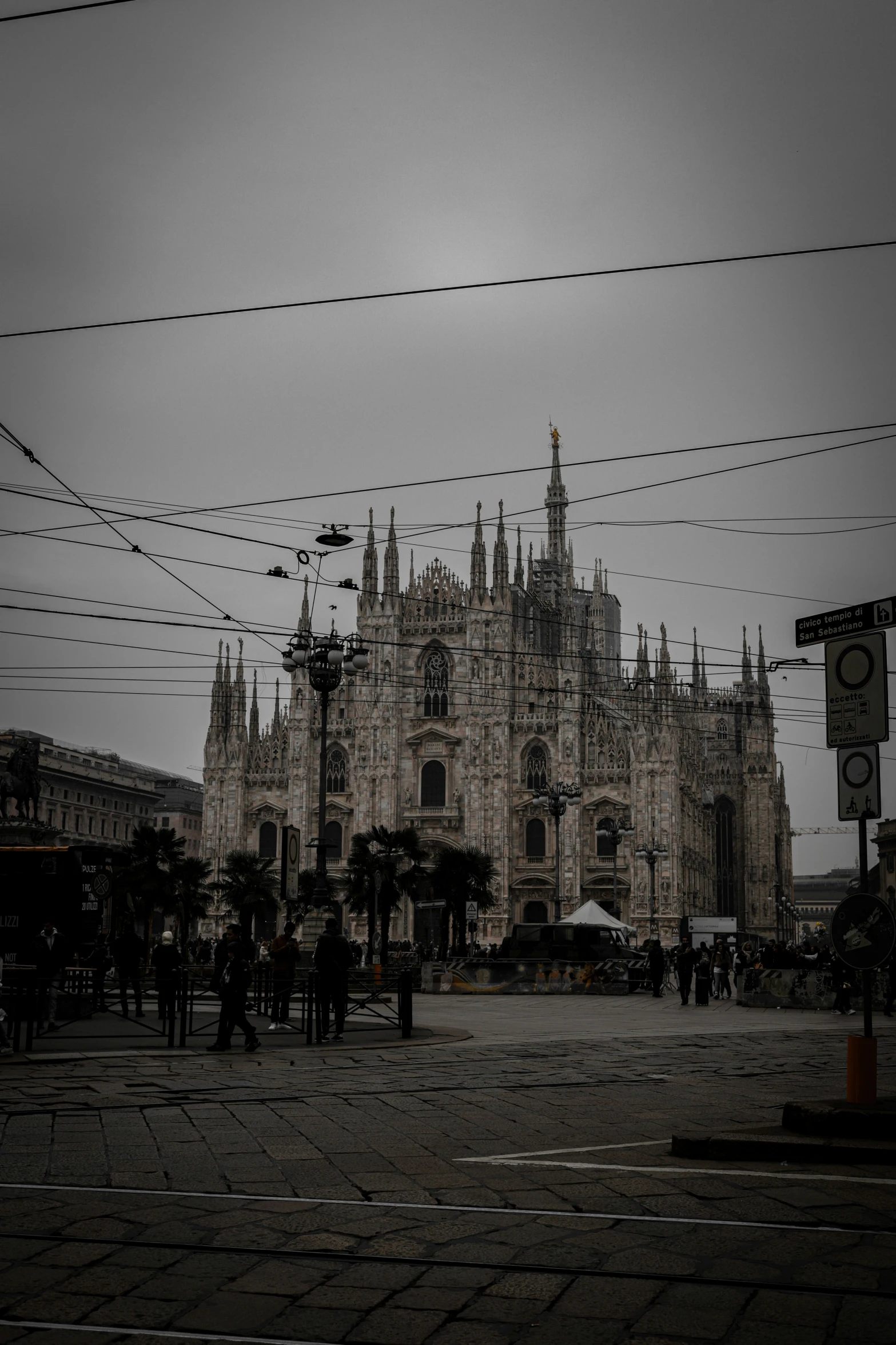 a building with several people walking around in front of it