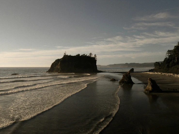 ocean waves roll across the sandy shore near the beach