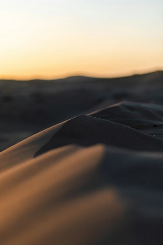 the sky above the sand dunes at sunset