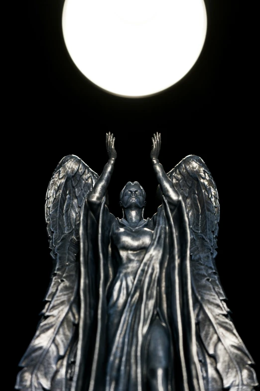 a statue holds up the moon above her