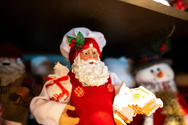 a santa figurine holding a pastry in his hand