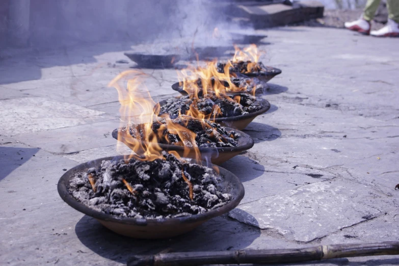 some very small bowls with flame in them