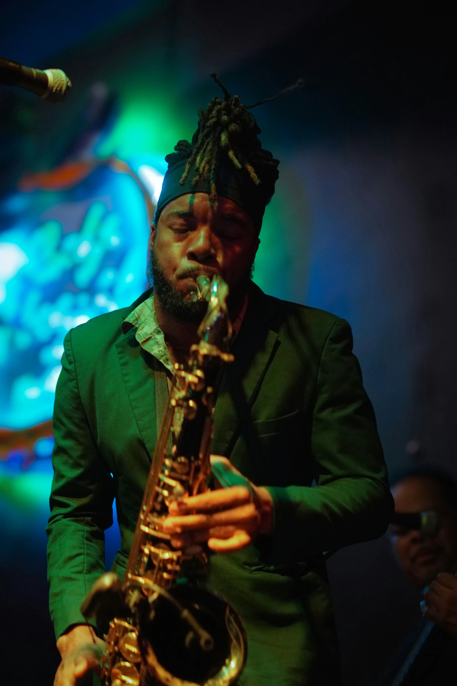 a man standing with his saxophone in his hands