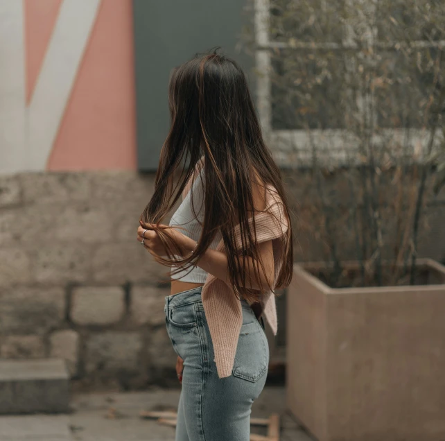 the young woman is looking away while walking