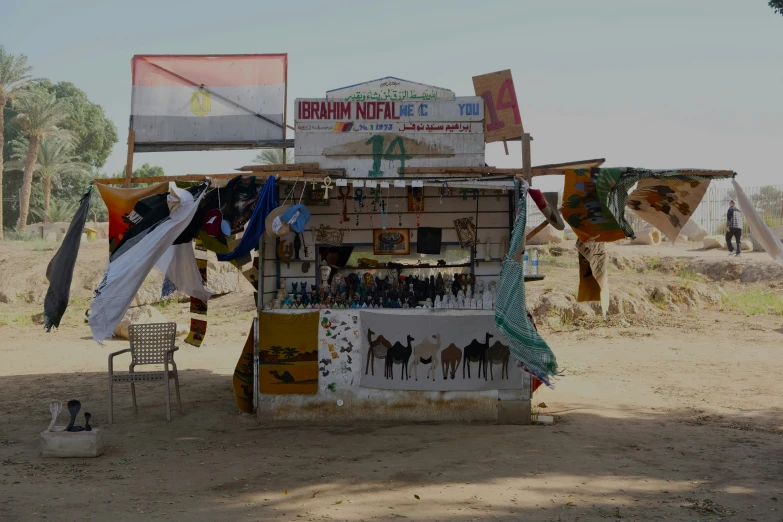 a store with lots of colorful banners and chairs next to it