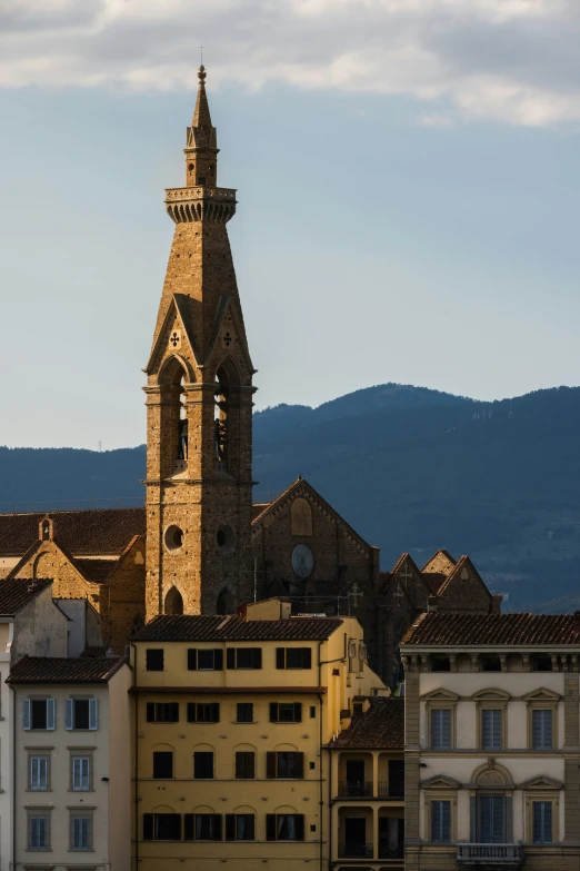 a tall tower with clocks in the middle of it