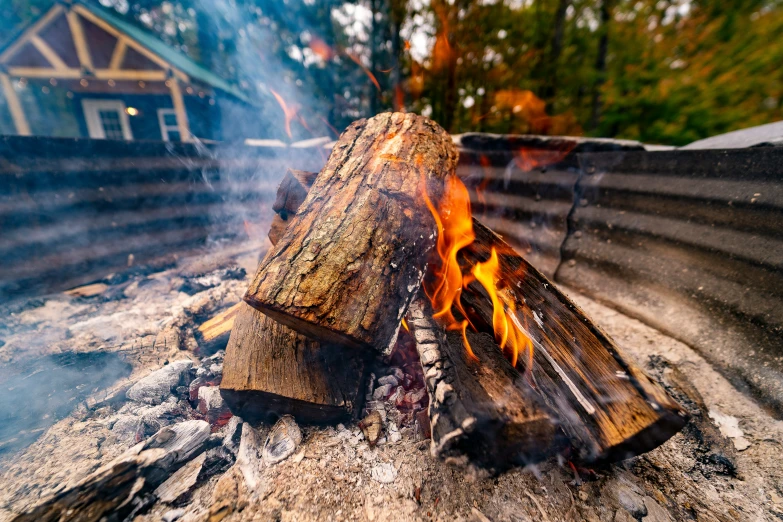 an open fire burning in the ground outside a home