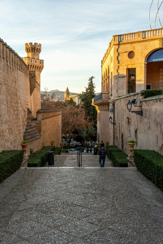 the cobblestone pathway between the two buildings leads to a patio