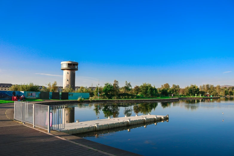 the clock tower is next to a body of water